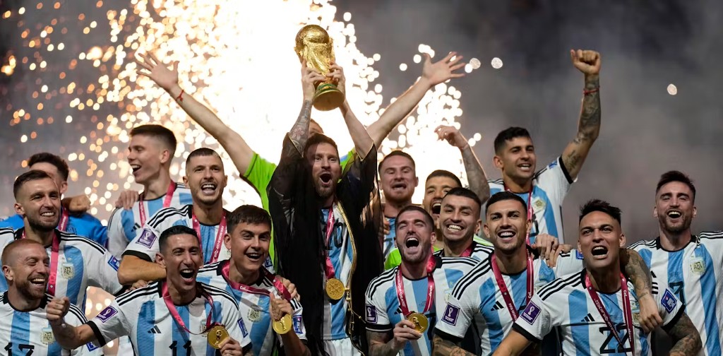 Argentina celebrate winning the FIFA World Cup, lifting the trophy amid golden fireworks